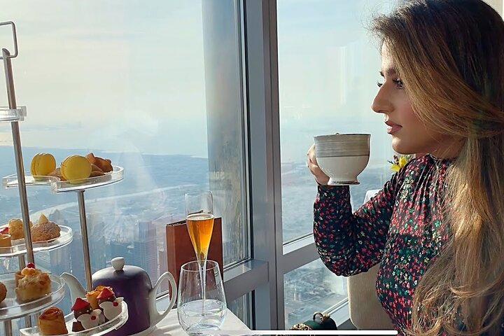 Experience high tea at At.mosphere where stunning views of Dubai and exquisite treats create a memorable luxurious dining escape in the skies above the city.